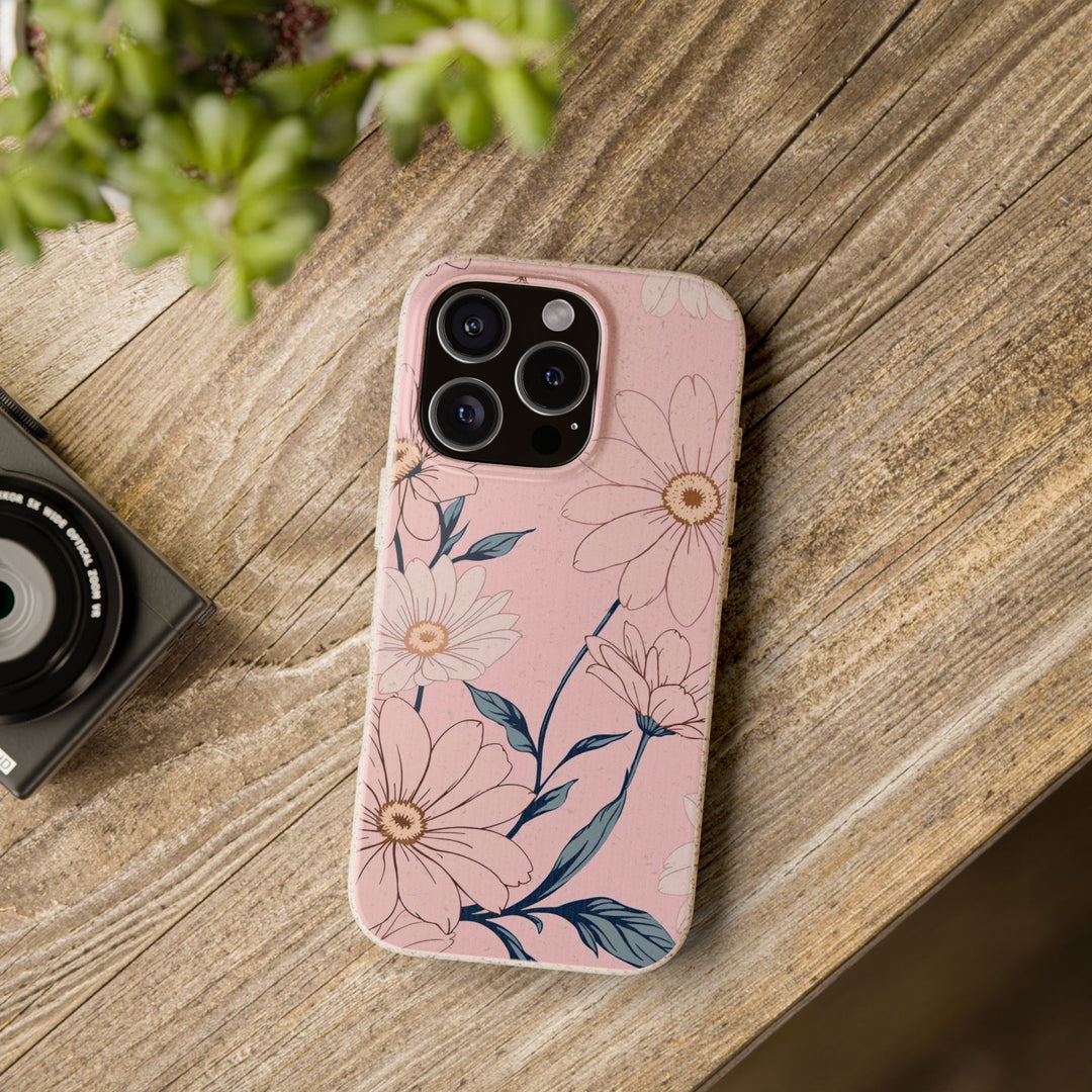 Pink eco-friendly floral phone case with durable design for many iPhone and Samsung models on wooden surface.