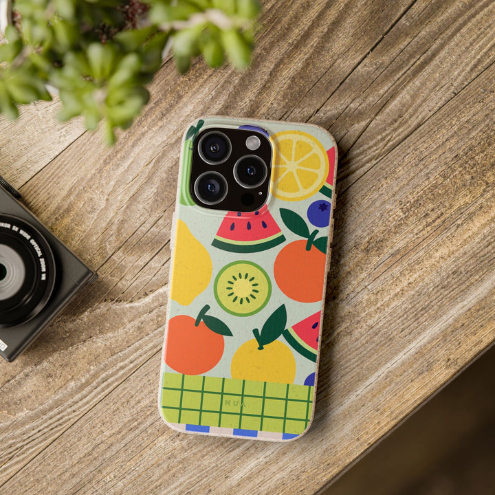 Fruity Fun Vibe Eco iPhone Case with vibrant fruit design on a wooden table, eco-friendly, stylish, and durable.
