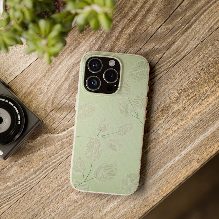 Eco-friendly green iPhone case on wooden table with leaf design, fits many iPhone and Samsung models, durable and stylish.