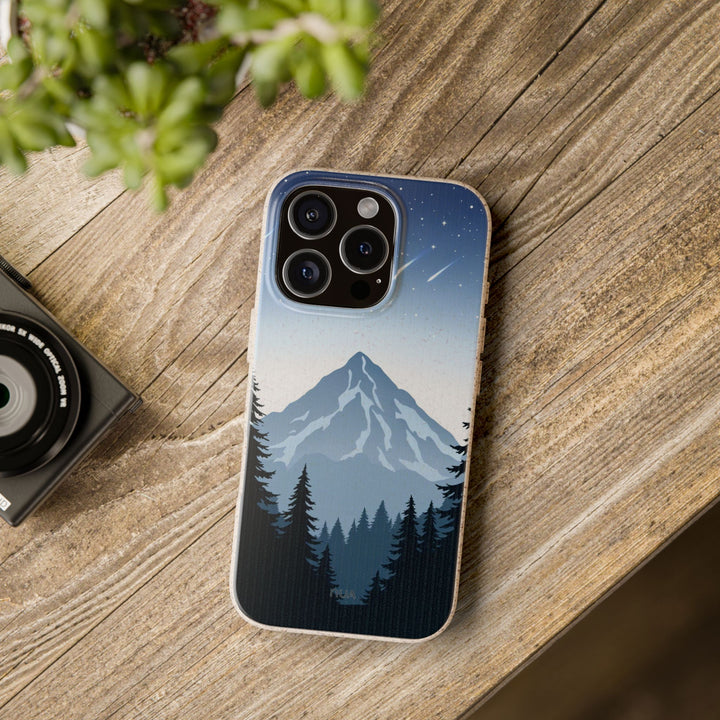 Eco-friendly biodegradable iPhone case with mountain design on a wooden table, perfect for nature lovers and available for many models.
