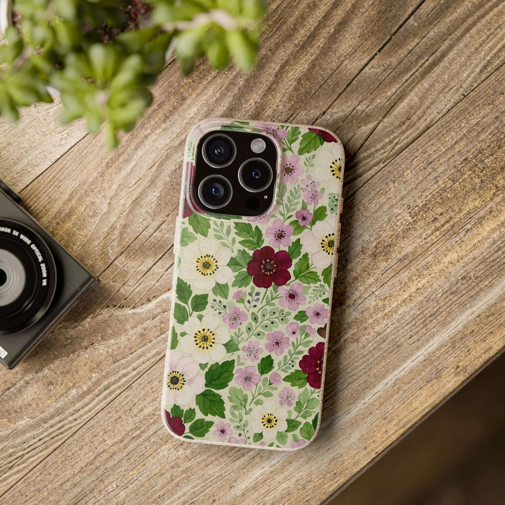 Eco-Friendly Wild Floral iPhone Case with vibrant colors on wooden table, showcasing durability and stylish nature-inspired design.