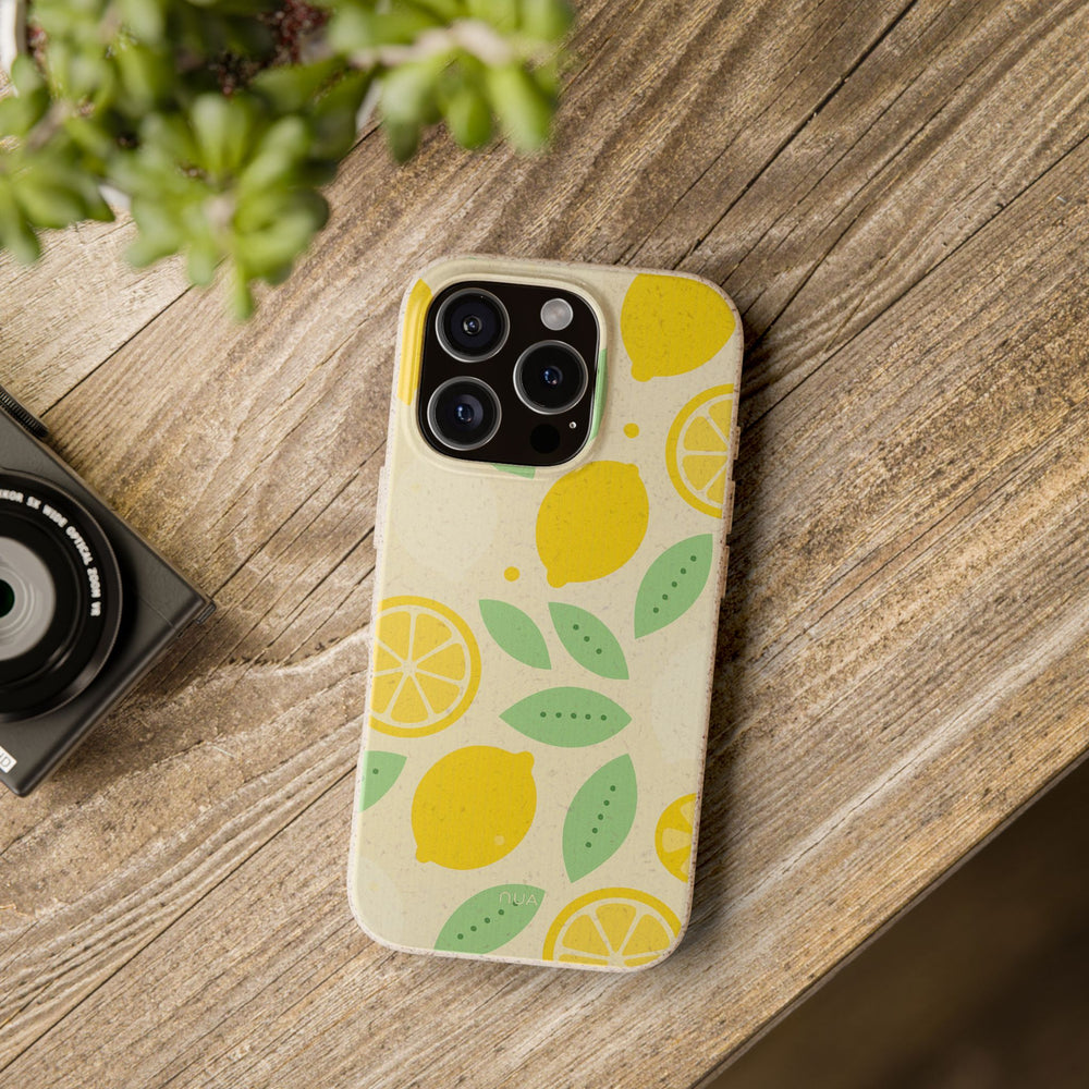 Citrus Pop iPhone case with vibrant lemon print on a wooden table, eco-friendly and durable, fits many iPhone and Samsung models.