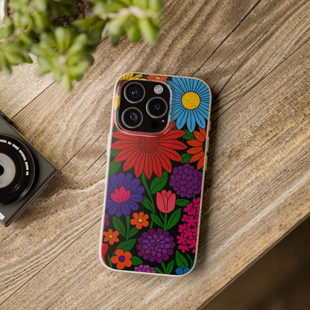 Flower Power Eco-Friendly iPhone Case with vibrant floral design, biodegradable materials, and matte finish on wooden table. Eco-friendly, stylish accessory.