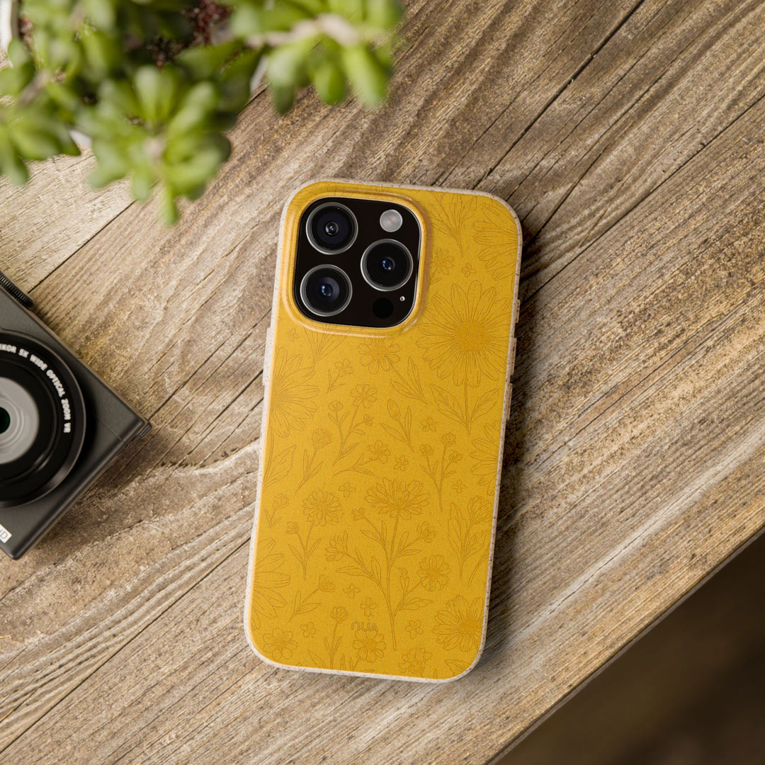Eco-friendly floral phone cover on a wooden table, compatible with iPhone and Samsung models, showcasing durable, chic design.
