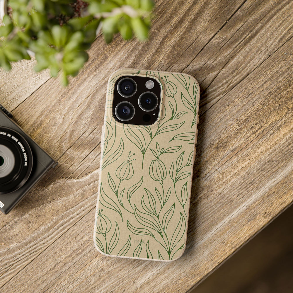 Eco-friendly biodegradable phone case with floral design on a wooden table, compatible with many iPhone and Samsung models.