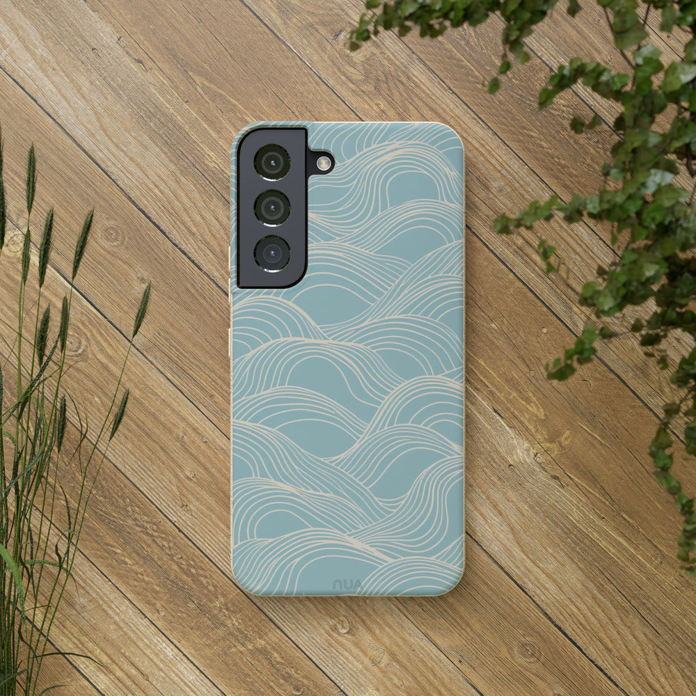Eco-friendly blue wave Samsung phone case on wooden surface, designed for durability and style, fitting various models.