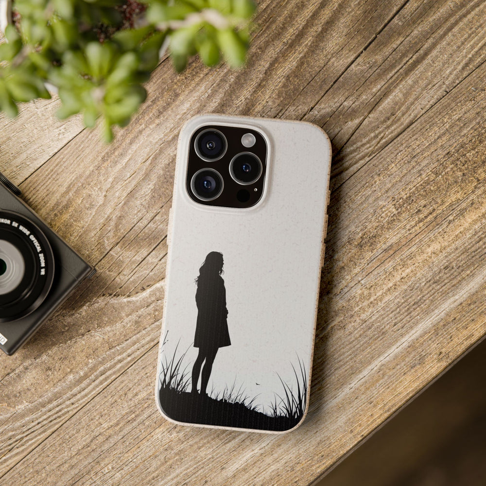 Eco-friendly iPhone cover with a silhouette design on wooden table. Durable and stylish, fits many iPhone and Samsung models.