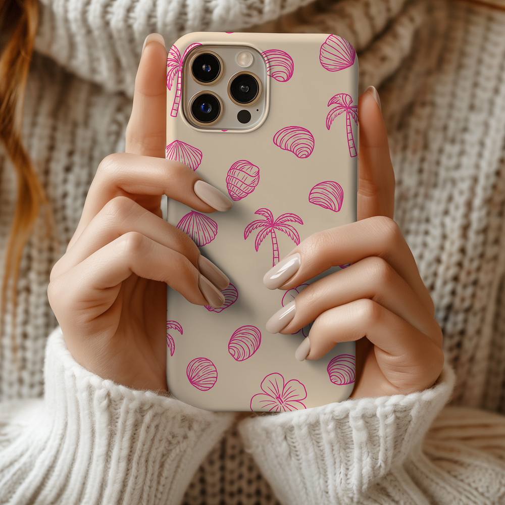 Person holding eco-friendly biodegradable iPhone case with pink tropical design, showcasing both style and sustainability.